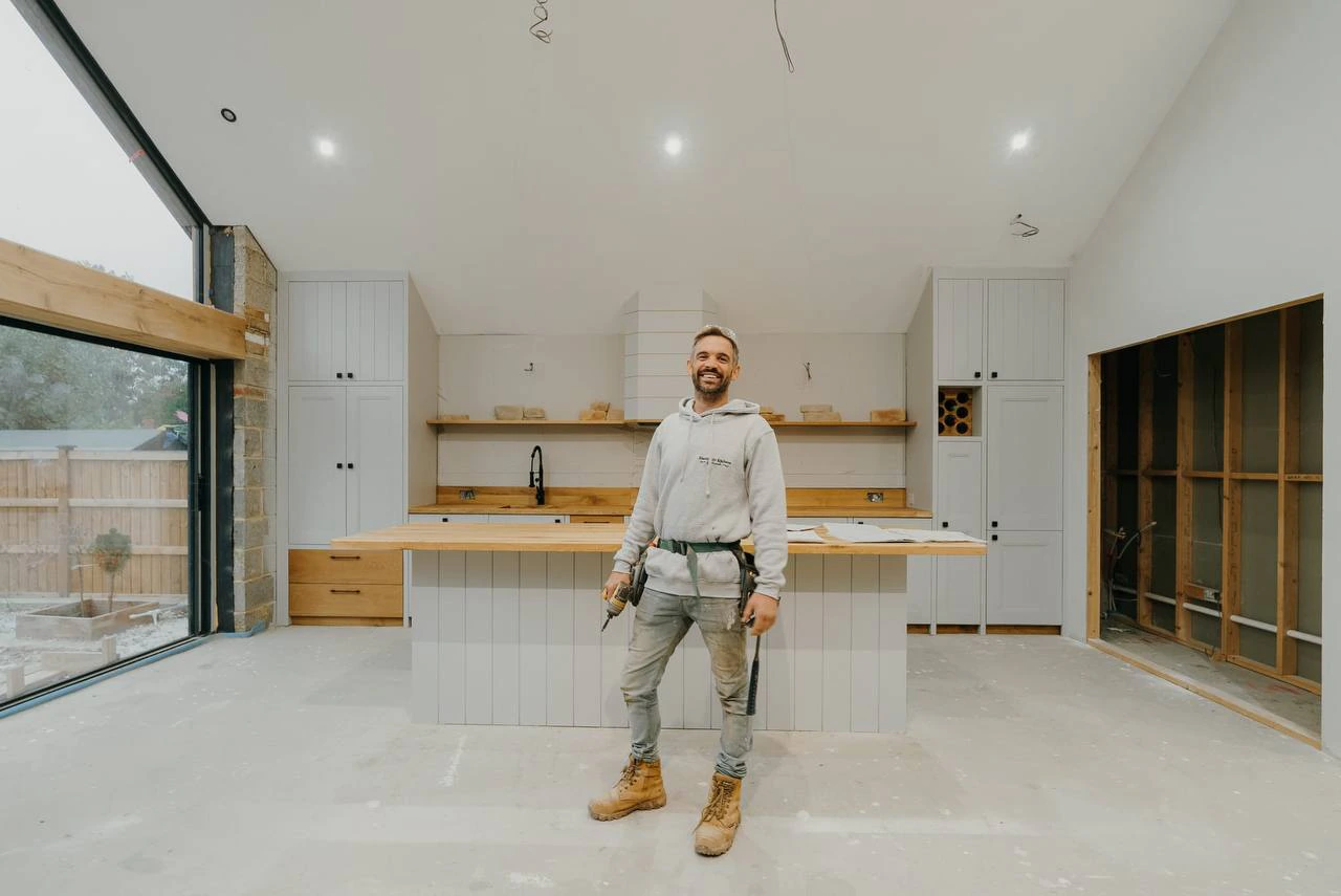 Christian, founder of Whitstable Kitchens, standing in an under-construction kitchen he is fitting